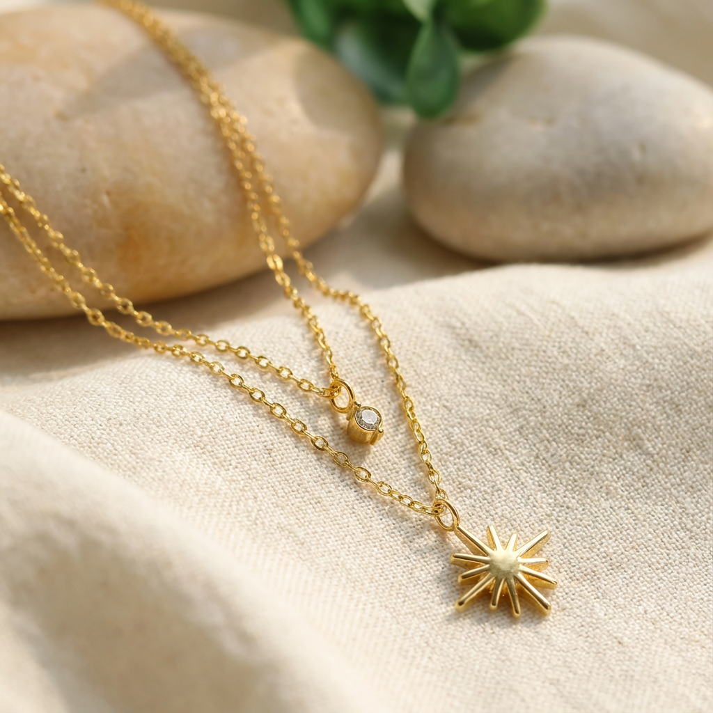 Layered gold necklaces with star charms and crescent moon pendant on white decorative dish