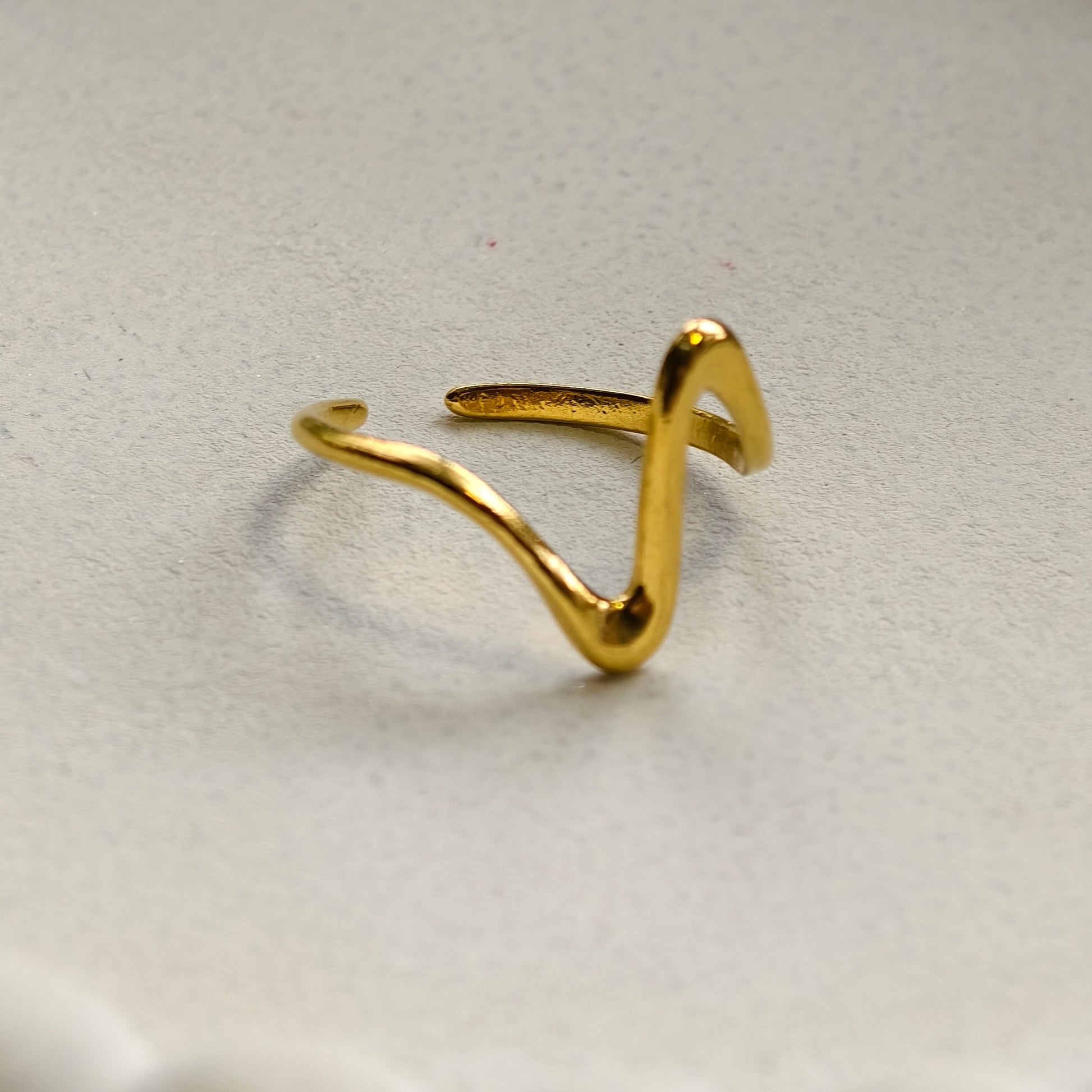 Gold ring on a textured white surface