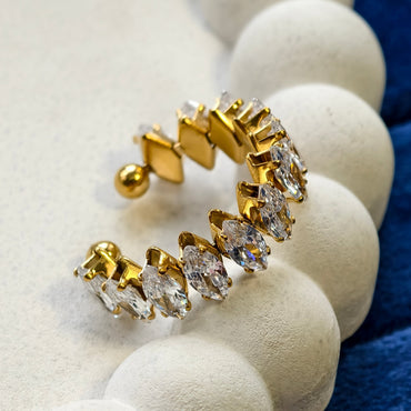 Gold and diamond ring on a white stone surface