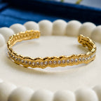 Gold bracelet with crystals on a white shell