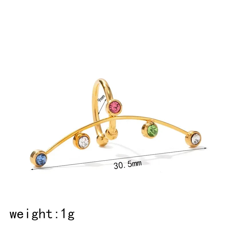 Pretty Shimmering Things gold-tone curved ear cuff with multi-colored bezel-set crystals in pink, green, blue, and clear.