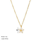 Pretty Shimmering Things gold-tone floral pendant necklace with cubic zirconia petals and a central gold bead.