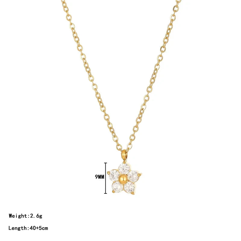 Pretty Shimmering Things gold-tone floral pendant necklace with cubic zirconia petals and a central gold bead.