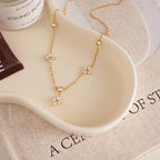 Pretty Shimmering Things gold-tone stainless steel station necklace with floral cubic zirconia accents.