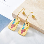 Pretty Shimmering Things Global gold-tone drop earrings featuring colorful leaf motifs on rectangular stainless steel