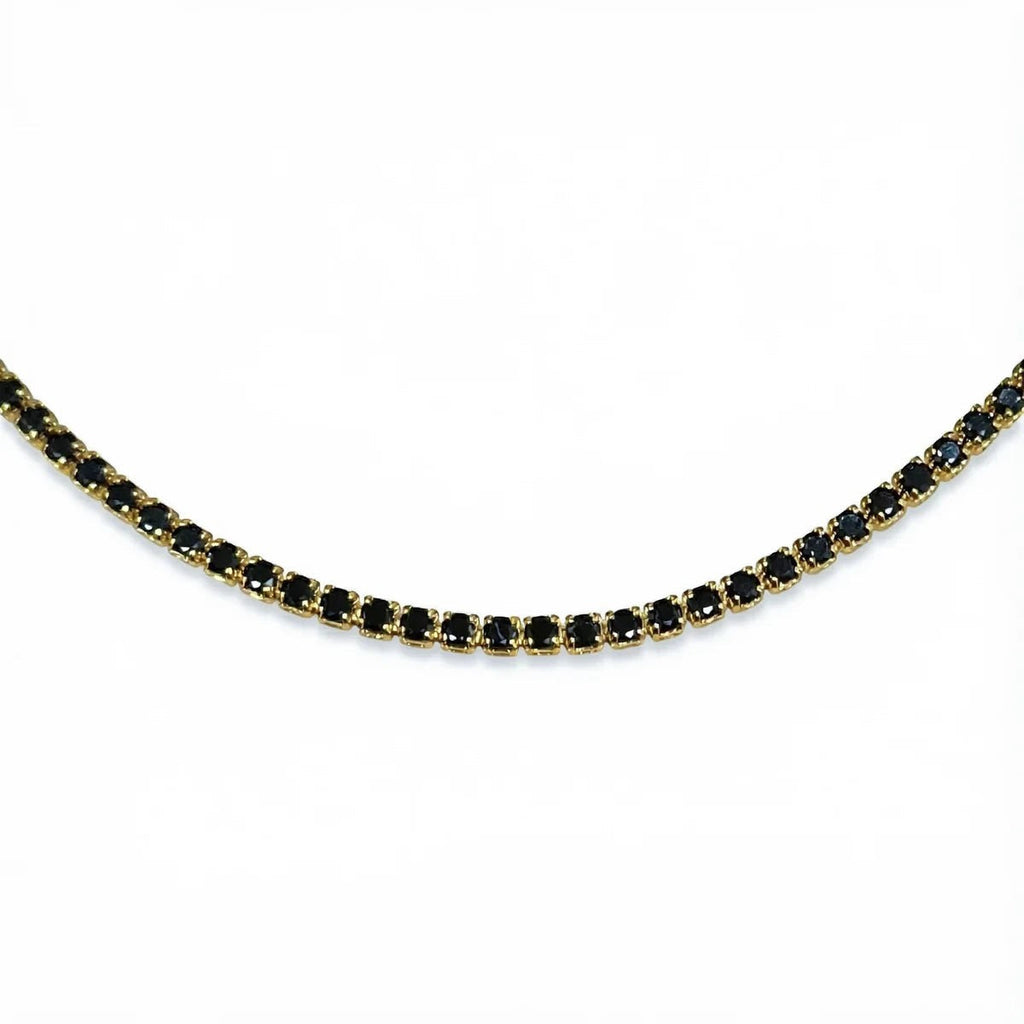 Pretty Shimmering Things Global gold-tone tennis necklace featuring a row of sparkling jet black crystals.