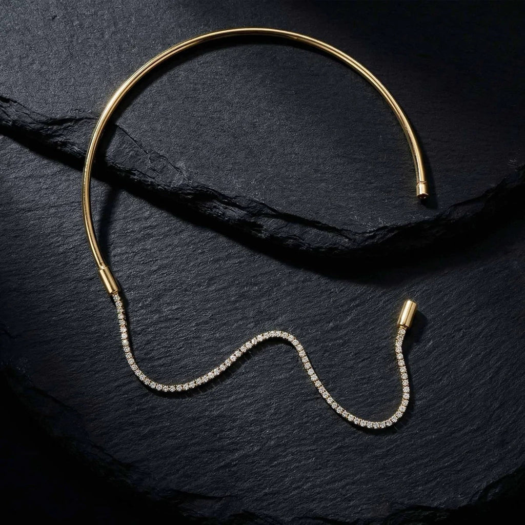 Pretty Shimmering Things Global gold-tone rigid collar necklace with a detachable sparkling crystal tennis chain.