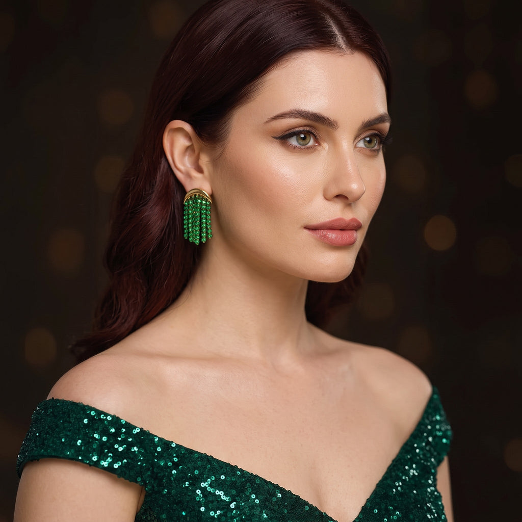 Pretty Shimmering Things Global Isla emerald green beaded fringe drop earrings with gold-tone accents on a model