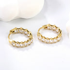Pretty Shimmering Things Global Lyra crystal hoop clips in 18K gold-plated stainless steel with zircon stones.