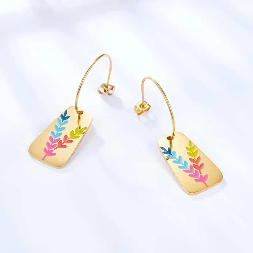 Pretty Shimmering Things Global gold-plated drop earrings featuring a vibrant, multi-colored leaf motif on rectangles.