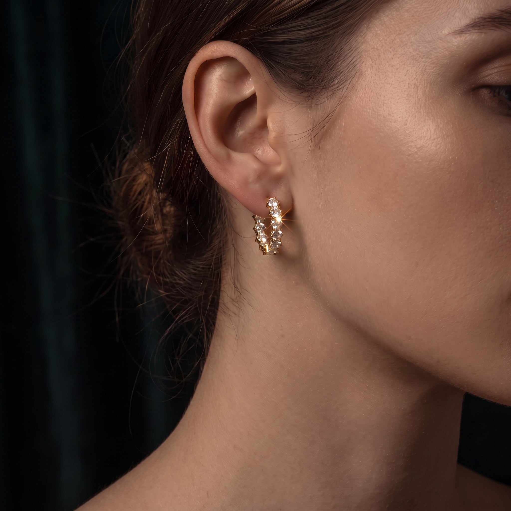Pretty Shimmering Things Global Lyra gold-plated hoop ear clips with sparkling zircon stones worn on a model
