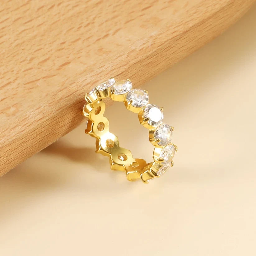 Pretty Shimmering Things Global Ivy white stone band featuring 18K gold plated stainless steel and 5A zircon stones.