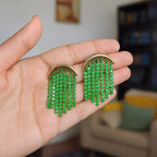Pretty Shimmering Things Global crescent fringe earrings with gold-tone arches and cascading green crystal strands.