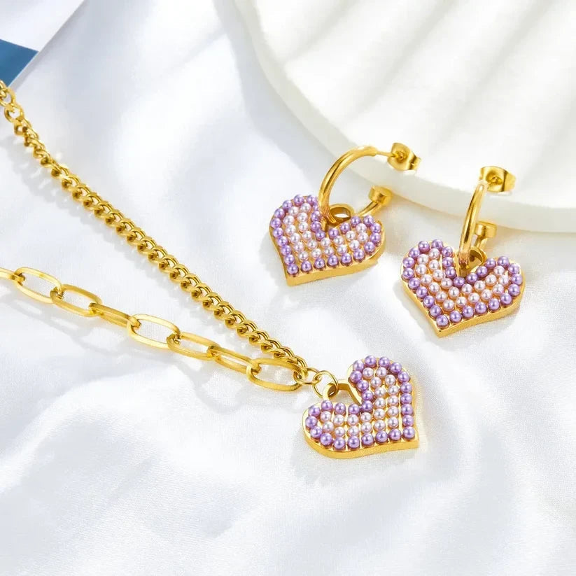 Pretty Shimmering Things Global Chloe heart charm necklace and hoop earring set with purple and white pearl accents.