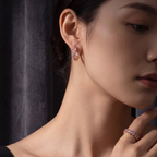 Pretty Shimmering Things Global Lyra lavender zircon hoop ear clips and matching ring worn by a woman
