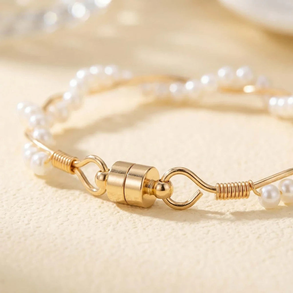 Pretty Shimmering Things Global twisted pearl bracelet with white pearls and gold-tone wire featuring a magnetic clasp