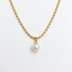 Pretty Shimmering Things gold-toned beaded chain necklace with a single lustrous white pearl pendant.