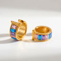 Pretty Shimmering Things gold-tone huggie hoop earrings with pink, blue, and purple baguette-cut crystals.