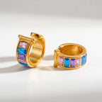 Pretty Shimmering Things gold-tone huggie hoop earrings with pink, blue, and purple baguette-cut crystals.