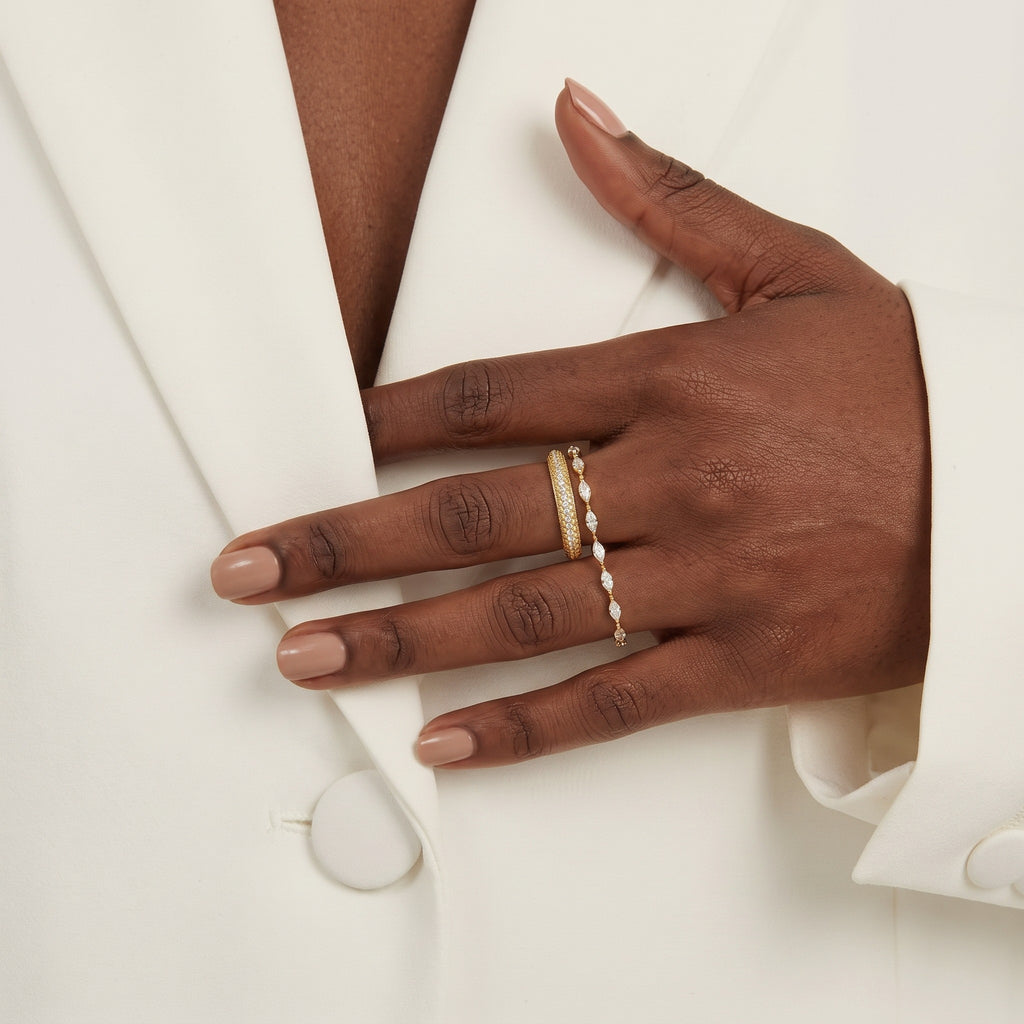 Pretty Shimmering Things Camille Gleam Ring Set featuring two gold-tone brass bands with crystal accents on a hand.
