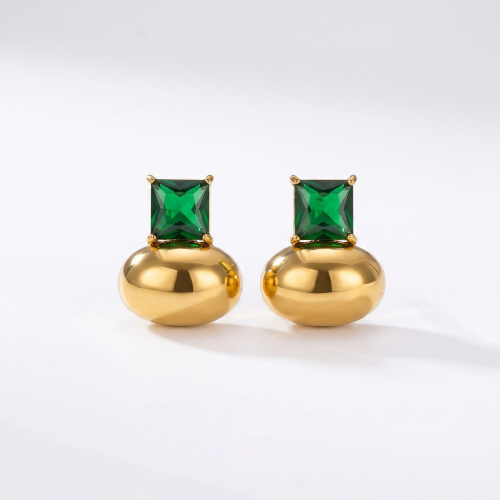 Pretty Shimmering Things gold-tone stud earrings featuring a polished metallic base and a square-cut emerald green crystal.