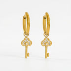 Pretty Shimmering Things gold-tone huggie hoop earrings with sparkling cubic zirconia key charms.