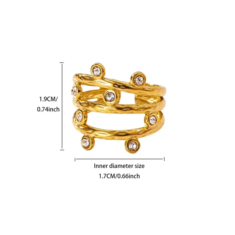 Pretty Shimmering Things gold-tone multi-layered statement ring with textured bands and bezel-set crystal accents.