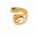 Pretty Shimmering Things gold-tone bypass ring featuring a marquise-cut clear crystal in a polished fluid design.