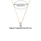 Pretty Shimmering Things gold-tone oval solitaire pendant necklace with a clear cubic zirconia stone on a delicate chain