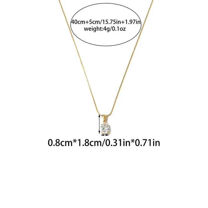 Pretty Shimmering Things gold-tone oval solitaire pendant necklace with a clear cubic zirconia stone on a delicate chain