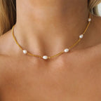 Pretty Shimmering Things gold-tone chain necklace featuring delicate freshwater pearls worn around the neck.