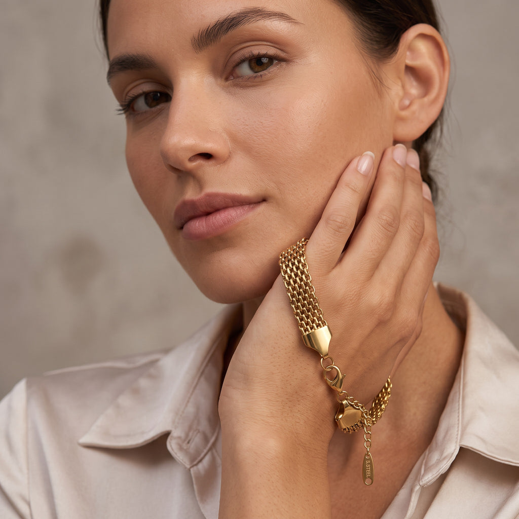 Pretty Shimmering Things gold-tone multi-strand woven stainless steel chain bracelet worn by a woman