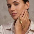 Pretty Shimmering Things gold-tone multi-strand woven stainless steel chain bracelet worn by a woman